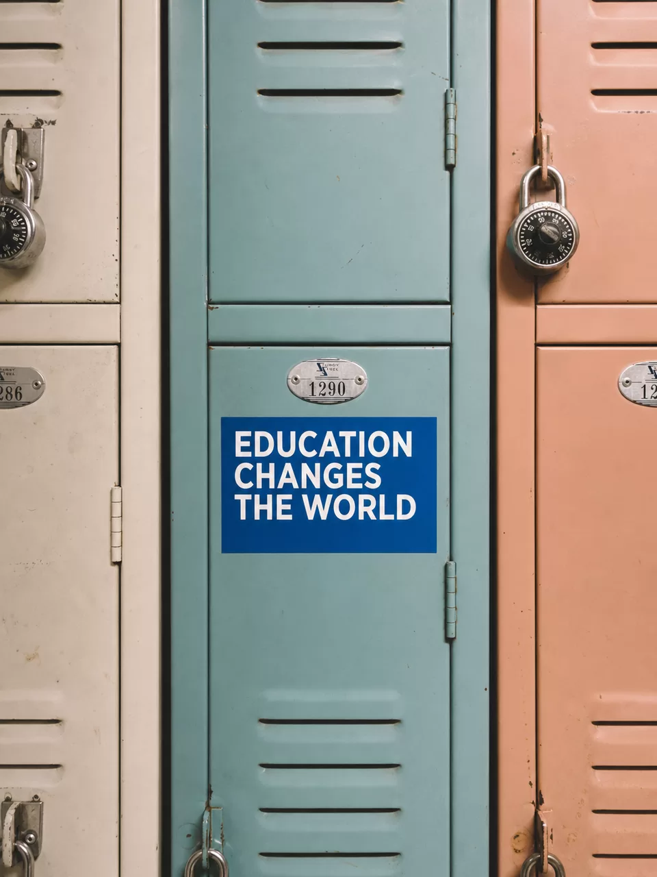 Teal, coral, and cream school lockers with a sign reading Education Changes the World