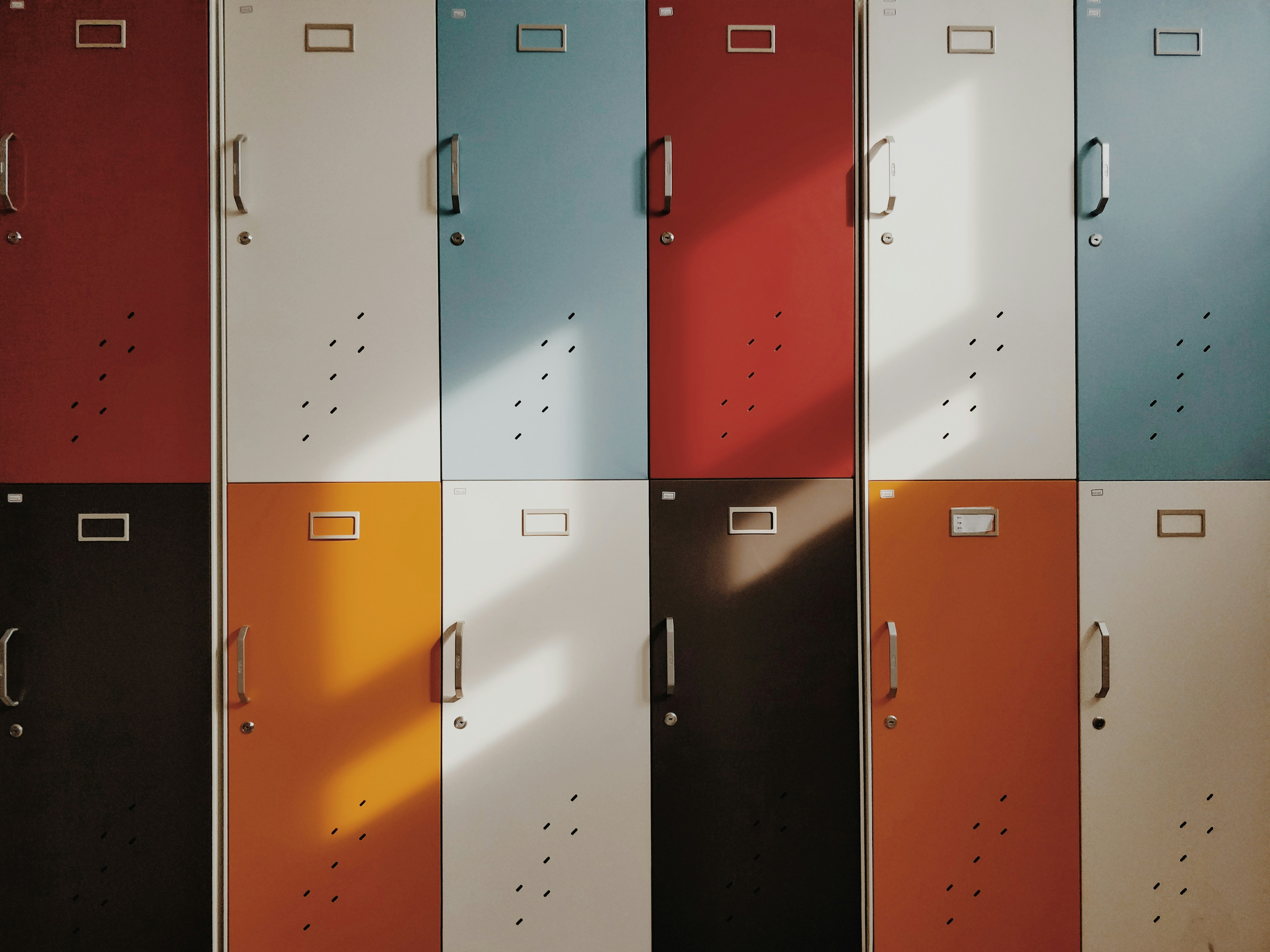 Rows of colorful school lockers in a hallway